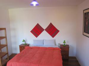 
a bedroom with a red bed and a red bedspread at Kurumi Hostel in Cusco
