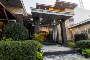 a house with a front entrance with plants at JJ hut hotel in Chiang Rai