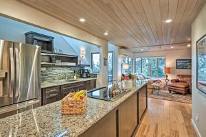 a kitchen with stainless steel appliances and a living room at 2 Mi to Heavenly Mountain Tahoe Retreat with Views in Stateline