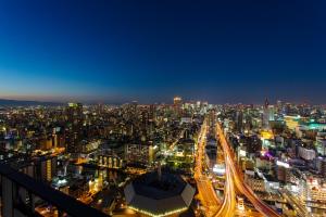 a view of a city at night with traffic at Hotel Monterey Grasmere Osaka in Osaka
