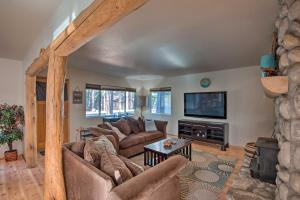 a living room with couches and a flat screen tv at Cozy Mountain Cabin about 7 Mi to Heavenly Ski Resort! in South Lake Tahoe