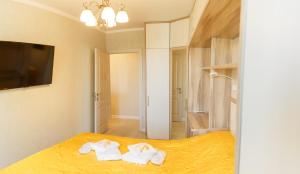 a bedroom with a bed with towels on it at Роскошные апартаменты RentHome в центре in Kemerovo