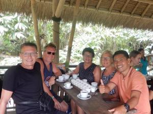 a group of people sitting at a table at New Danas Canggu Guest House in Kerobokan
