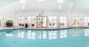 a swimming pool with blue water in a building at Holiday Inn Express Hotel & Suites San Jose-Morgan Hill by IHG in Morgan Hill