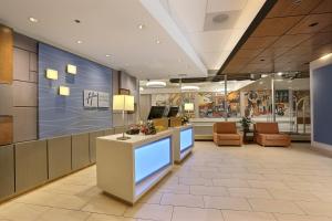 a lobby of a store with a reception desk and chairs at Holiday Inn Express Denver Downtown, an IHG Hotel in Denver