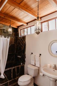 a bathroom with a toilet and a sink at Korakia Pensione in Palm Springs