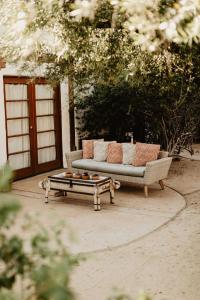 a couch and a coffee table on a patio at Korakia Pensione in Palm Springs