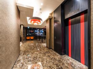 a hallway of a hotel lobby with a marble floor at Ai Hotel Keikyu Kamata in Tokyo