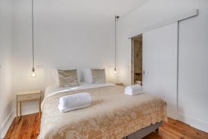 a bedroom with a large bed with a mirror at Saldanha Pool & Garden in Lisbon