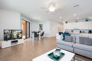 a living room with a couch and a tv at Large family friendly Vacation Home, Private Pool, Golf course location, Nr Orlando Disney Parks Florida in Davenport