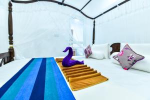 Postel nebo postele na pokoji v ubytování Peacock Beach Hotel Unawatuna
