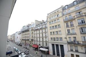 a view of a city street with cars and buildings at LAFAYETTE HOTEL in Paris