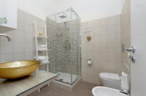 a bathroom with a sink and a shower and a bowl sink at Deluxe rooms and Chilling Jacuzzi Suite Guesthouse in Rome