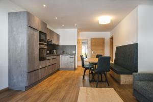 a kitchen and living room with a table and chairs at Appartement Botenwirt in Kleinarl