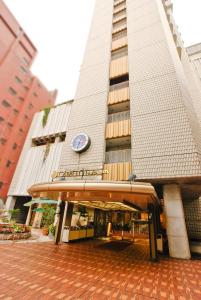 a tall building with a clock on the front of it at Hotel Yokohama Camelot Japan in Yokohama