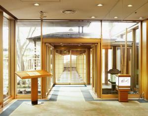 a building with a hallway with glass windows and a staircase at Hotel Yokohama Camelot Japan in Yokohama