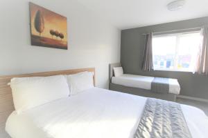 En eller flere senger på et rom på Citilodge Wakefield Hotel by Roomsbooked