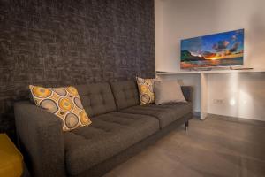 a living room with a couch with pillows on it at MORE Podgora Luxury Design Apartment in Podgora