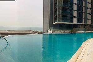 a swimming pool with a view of a building at Stunning 3 bedroom apartment in Bluewaters Island in Dubai