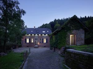 a large brick house with lights on it at seehaus forelle haeckenhaus in Ramsen