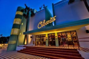 a building with a neon sign in front of it at Cubanito Ibiza in San Antonio