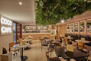 a restaurant with tables and chairs and a counter at Secrets Lanzarote Resort & Spa - Adults Only (+18) in Puerto Calero