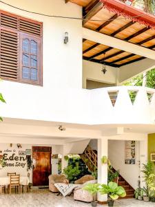 a house with a living room and a patio at Eden Homestay in Hikkaduwa