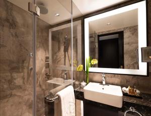 a bathroom with a sink and a mirror at Taj Coromandel in Chennai
