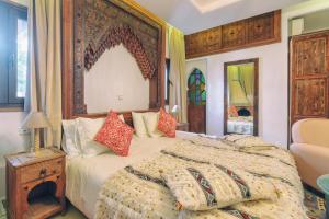 a bedroom with a large bed with a wooden headboard at Dar Baibou in Chefchaouen