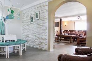 a living room with a brick wall at Casa Roua Muntilor in Câmpulung Moldovenesc