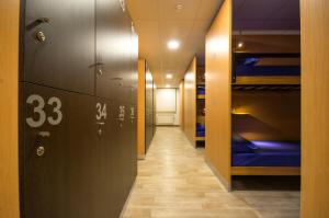 a corridor of a dorm room with bunk beds at Albergue Piñeiral Fonsagrada in Fonsagrada
