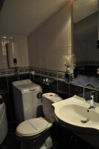 a bathroom with a toilet and a sink at Comfort Deluxe Kosmos Apartments in Ohrid