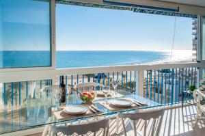a balcony with a table with a view of the ocean at MyFlats Azul in El Campello