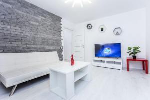 Una televisión o centro de entretenimiento en Apartments Roomer