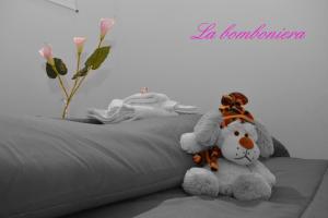 a teddy bear sitting on top of a bed at La Bomboniera in Maiori