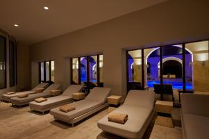 a living room with couches and chairs and windows at Secrets Lanzarote Resort & Spa - Adults Only (+18) in Puerto Calero
