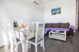 a living room with a table and a couch at Apartments Mate in Tučepi