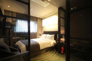 Postel nebo postele na pokoji v ubytování Best Louis Hamilton Hotel Haeundae