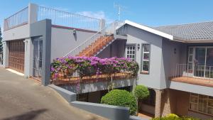 a house with a balcony with flowers on it at SeA WaVes in Densainagar