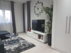 a living room with a flat screen tv on a white entertainment center at Palladium II City Center Apartments in Makarska