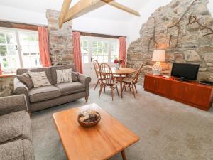 a living room with a couch and a table at Treverbyn Smithy in Saint Neot