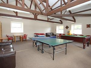 a room with a ping pong table and chairs at Dartmoor Valley Lodge 10 in Gunnislake