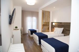 Llit o llits en una habitació de Hotel Veleiro