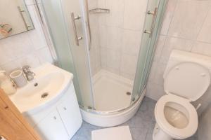 a bathroom with a shower and a toilet and a sink at Apartments Mate in Tučepi +18 photos