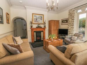 a living room with two couches and a fireplace at The Station House in Whitby