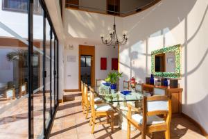 a dining room with a glass table and chairs at ViVa Royal - Immense villa, unique and exclusive in Chayofa