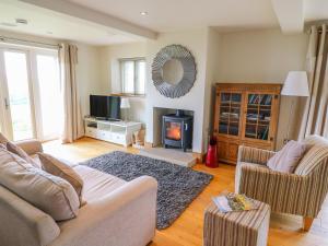 a living room with a couch and a fireplace at Cottam Cottage Farm in Longridge