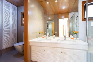 a bathroom with two sinks and a toilet at ViVa Royal - Immense villa, unique and exclusive in Chayofa +25 photos