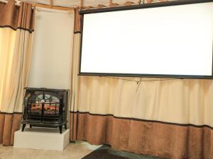 a living room with a fireplace and a window at Island Yurt in Beckford