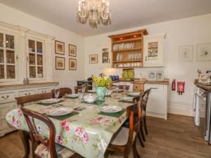 a kitchen with a table with chairs and a dining room at Manor Farm in Hutton Bushel